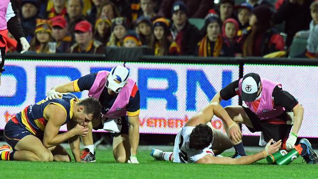 Paddy McCartin on the ground after clashing heads with Adelaide’s Luke Brown. Picture: Tom Huntley