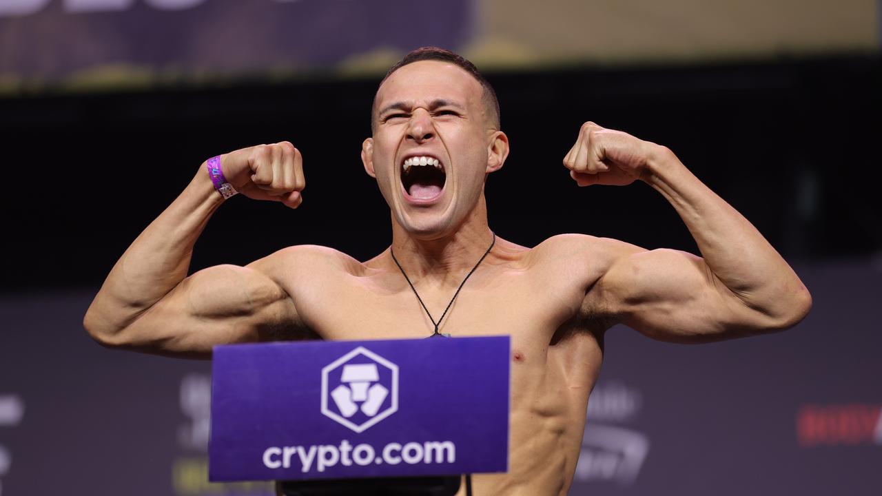 LAS VEGAS, NEVADA – DECEMBER 10: Kai Kara-France of New Zealand poses on the scale during the UFC 269 ceremonial weigh-in at MGM Grand Garden Arena on December 10, 2021 in Las Vegas, Nevada. Carmen Mandato/Getty Images/AFP == FOR NEWSPAPERS, INTERNET, TELCOS &amp; TELEVISION USE ONLY ==