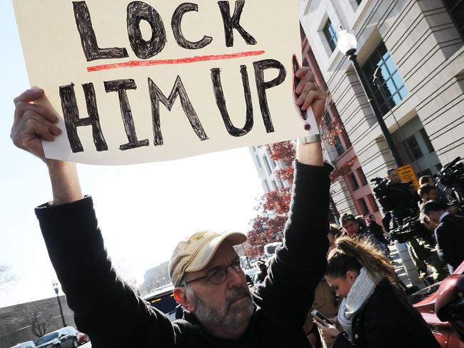 A handful of demonstrators held signs outside the Washington courthouse where Michael Flynn pleaded guilty to lying to the FBI. Picture: Chip Somodevilla/Getty Images/AFP