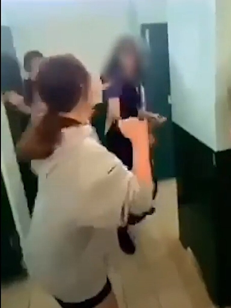 Screen-grabs of two girls from the Bundaberg North State High School having a fight in the girls toilets / changeroom.