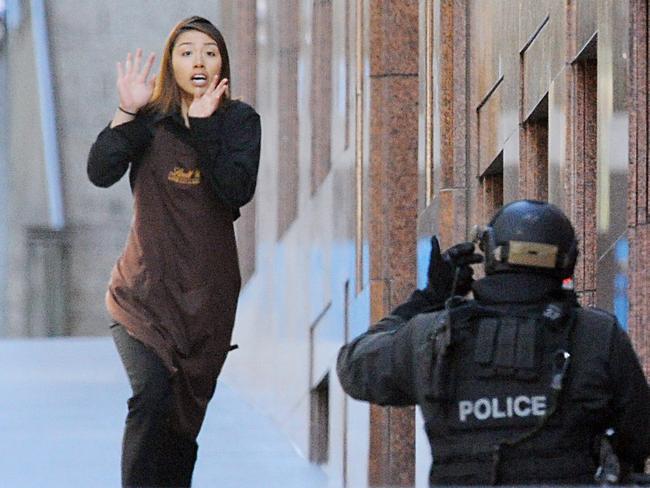 A hostage runs from the Lindt Cafe. Picture: Joel Carrett