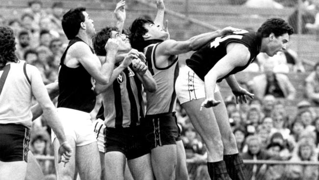 Justin Madden (right) prepares to land after being pushed in a pack featuring, from left, Gary Ayres, Peter Sartori, Paul Abbott and Chris Langford in a semi-final at VFL Park.