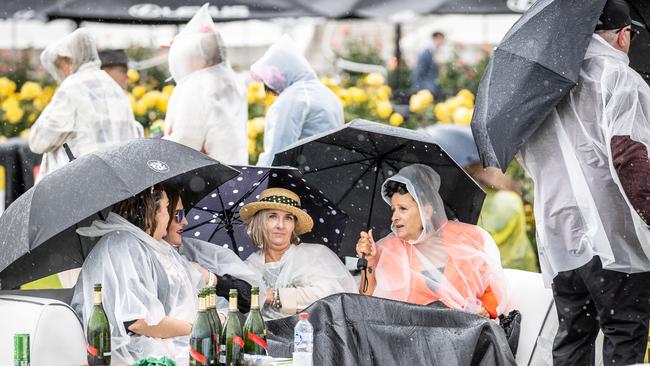 Cold, wet weather sets in at Flemington for Melbourne Cup Day. Picture: Jake Nowakowski