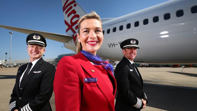 Andrew Hart (captain), Monica Jove-Fernandez (guest services) and Andy Bauer (base manager) all work for Virgin Australia at Brisbane Airport. Picture: Adam Head