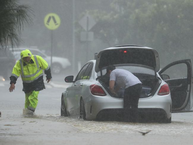 A Mercedes stuck in floods on the northern beaches this week after the driver attempted floodwaters on Boondah Rd Warriewood. Picture John Grainger