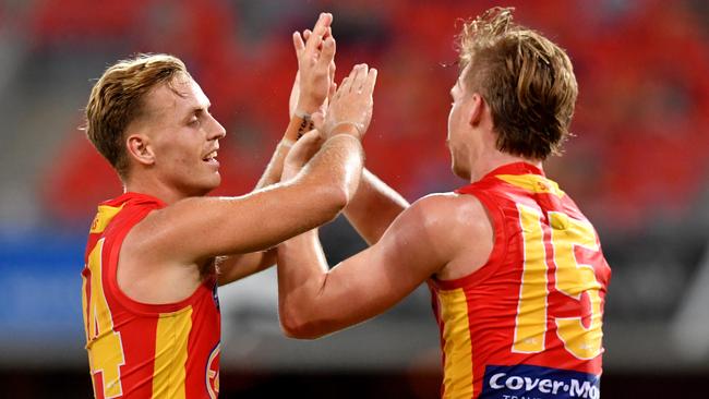 Darcy Macpherson (left) wants to stay on the Gold Coast.