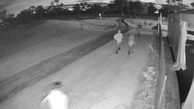 Youths run away from the Katherine Country Club on the early hours of Monday morning after Police arrived at the premises. Picture: Supplied