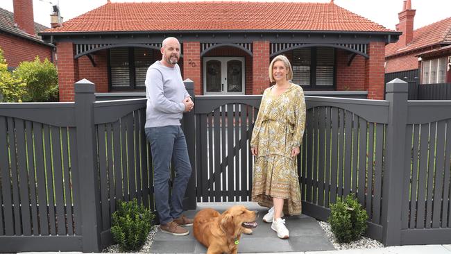 Tim and Caroline Sharp, with 10-month-old golden retriever Wilby, at their St Kilda East house, which is for sale with a $2.9m-$3.19m price guide. Picture: David Crosling