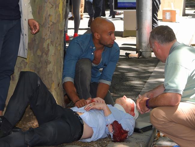 An injured man in Bourke St, Melbourne. Picture, Tony Gough