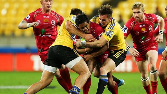 <b>WELLINGTON, NEW ZEALAND - APRIL 26: Ben Tapuai of the Reds is tackled by Jack Lam and Andre Taylor of the Hurricanes during the round 11 Super Rugby match between the Hurricanes and the Reds at Westpac Stadium on April 26, 2014 in Wellington, New Zealand. (Photo by Hagen Hopkins/Getty Images)</b>