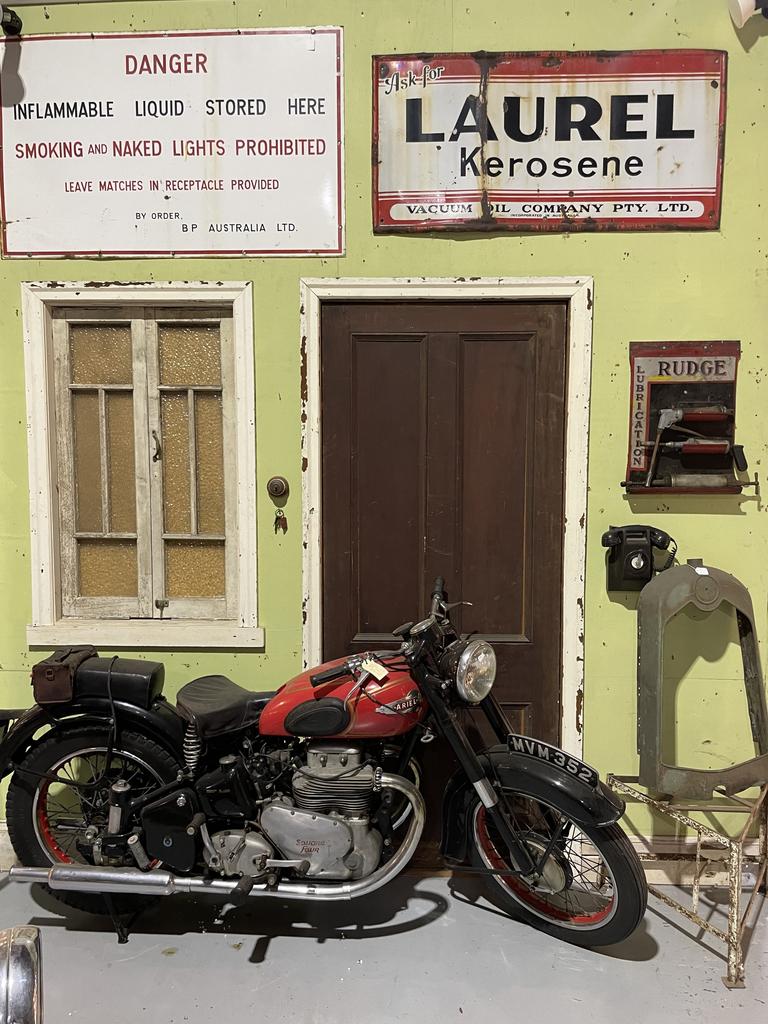 Vintage motorcycle and signage from Roadside Relics on Brisbane Road, Gympie.