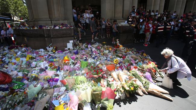 Bourke St was blanketed with flowers in tribute to massacre victims. Picture: David Crosling