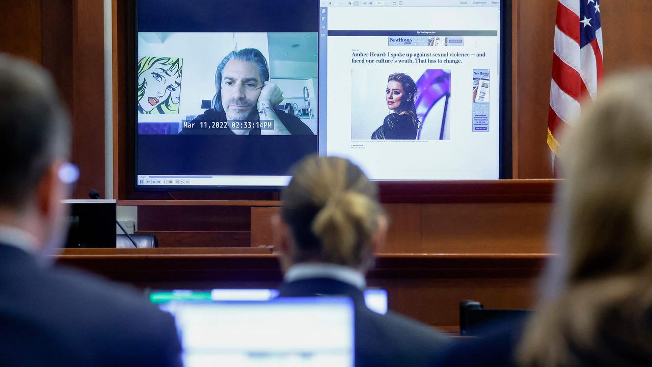 Actor Johnny Depp watches a prerecorded deposition testimony of Christian Carino during Depp's defamation trial against his ex-wife Amber Heard. (Photo by JONATHAN ERNST / POOL / AFP)