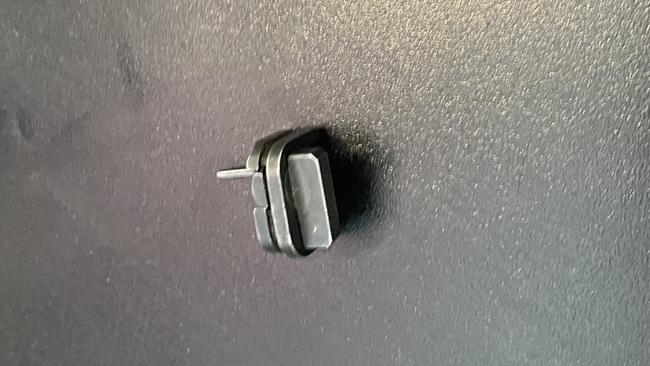 This is an example of a gun switch. A small device that can be attached to the rear of the slide of a Glock handgun, converting the semi-automatic pistol.