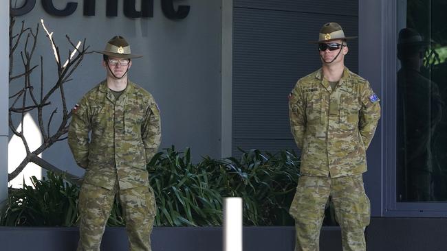 Australian Defence Force personnel stand outside the Ibis Airport Hotel in Brisbane after passengers arriving from international flights were taken for quarantine. Picture: AAP.