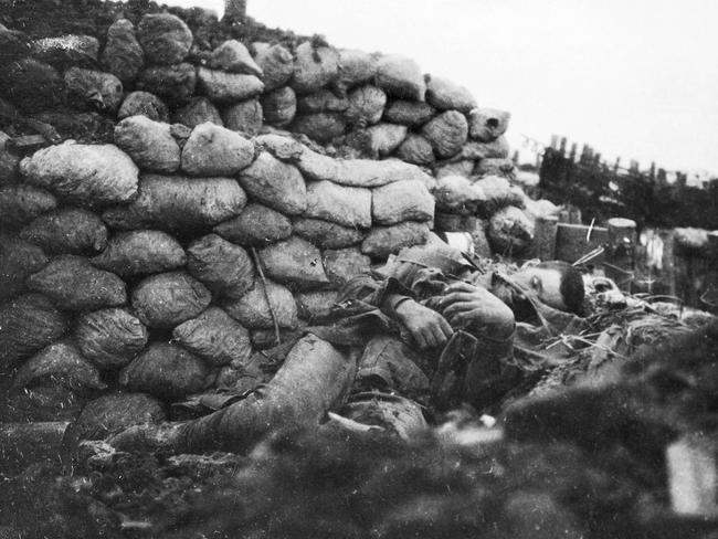 The body of an Australian soldier lies in a German trench the morning after the battle. The photograph, taken by a Bavarian intelligence officer, was given to Captain Charles Mills after the armistice in 1918. AWM A01566