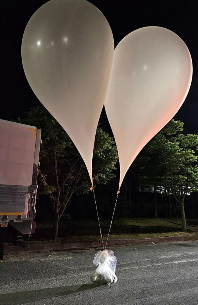 Unidentified objects believed to be excrement and North Korean propaganda material attached to balloons on a street in Chungnam Province. (Photo by Handout / South Korean Defence Ministry / AFP)