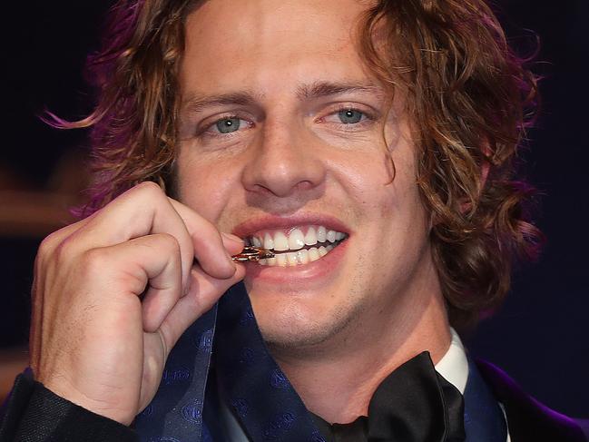 Brownlow Medal at Crown Casino, Melbourne. 23/09/2019.   Winner fremantles Nat Fyfe bites the Brownlow Medal   . Pic: Michael Klein.