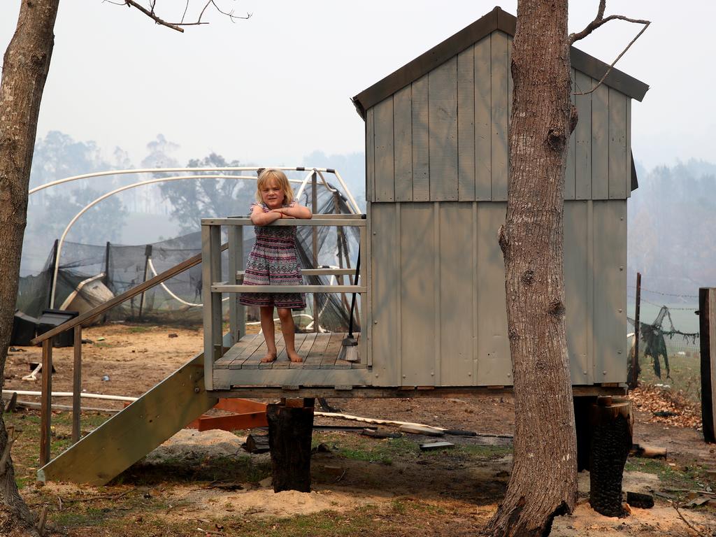 Five-year-old Layla Rixon of Wandella at her cubby house, which survived the bushfire that incinerated her family’s home. Per Capita estimates only about half of the promised funding for bushfire affected communities has actually been sent out. Picture: Toby Zerna