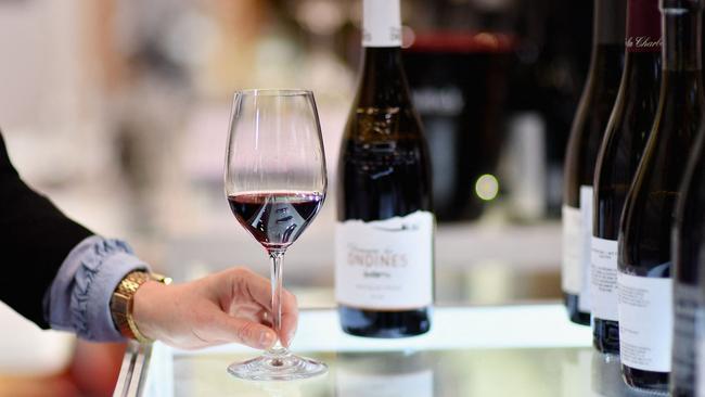 (FILES) An exhibitor swirls a glass of red wine during the Vinexpo at Javits Center on March 2, 2020 in New York City. As President-elect Donald Trump vows sweeping tariffs on even America's close partners once in office, US wine merchants and restaurateurs are watching with trepidation -- and pushing for exclusions they say will protect small businesses. (Photo by Angela Weiss / AFP)