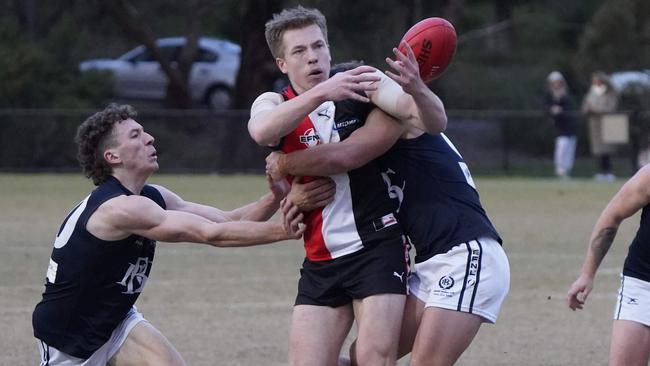 EFL: North Ringwood’s gets wrapped up in the tackle. Picture: Valeriu Campan