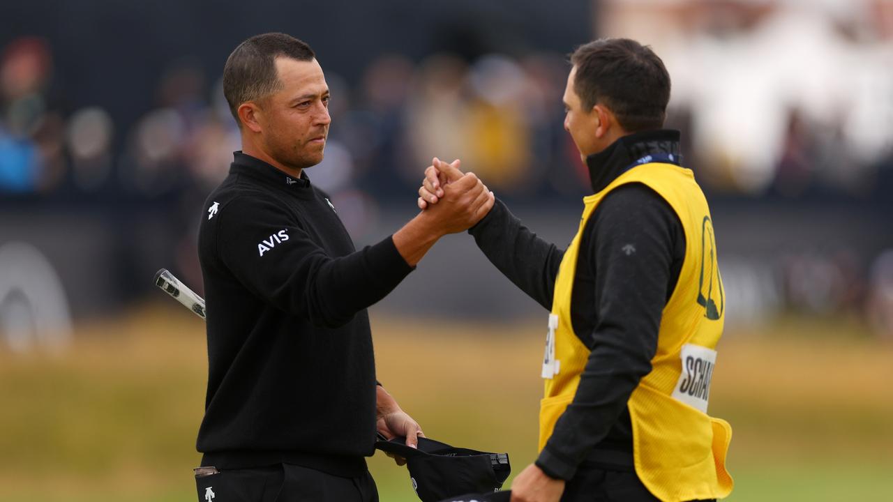 Xander Schauffele celebrates with his caddie Austin Kaiser. (Photo by Andrew Redington/Getty Images)