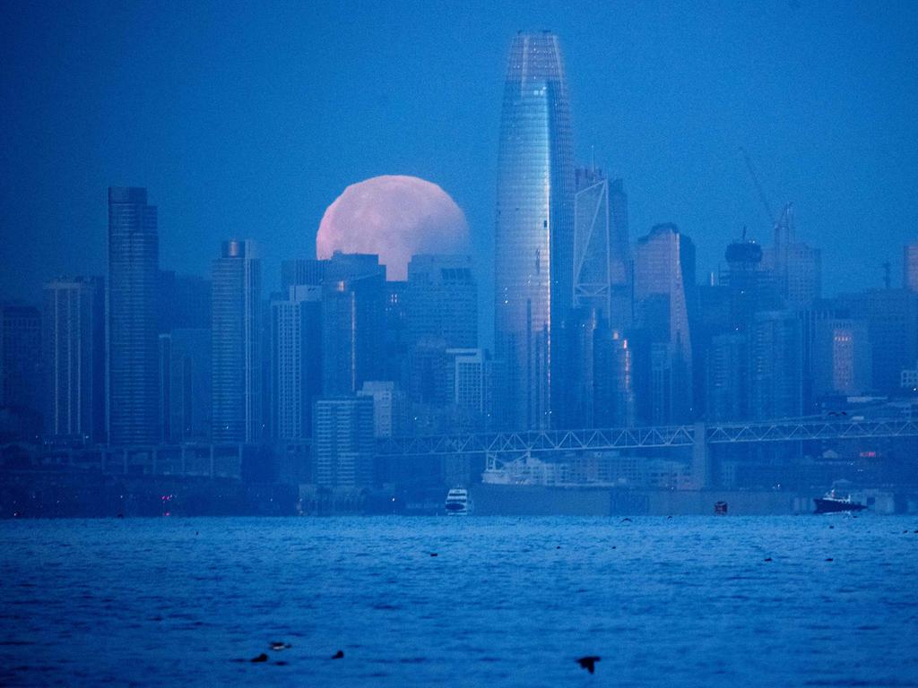 A super blue blood moon sets behind downtown San Francisco, California before dawn on January 31, 2017. For the first time in 35 years, a blue moon synced with both a supermoon and a total lunar eclipse in what NASA calls a lunar trifecta. Stargazers across large swathes of the globe -- from the streets of Los Angeles to the slopes of a smouldering Philippine volcano -- had the chance to witness a rare “super blue blood Moon” Wednesday, when Earth’s shadow bathed our satellite in a coppery hue. Picture: AFP