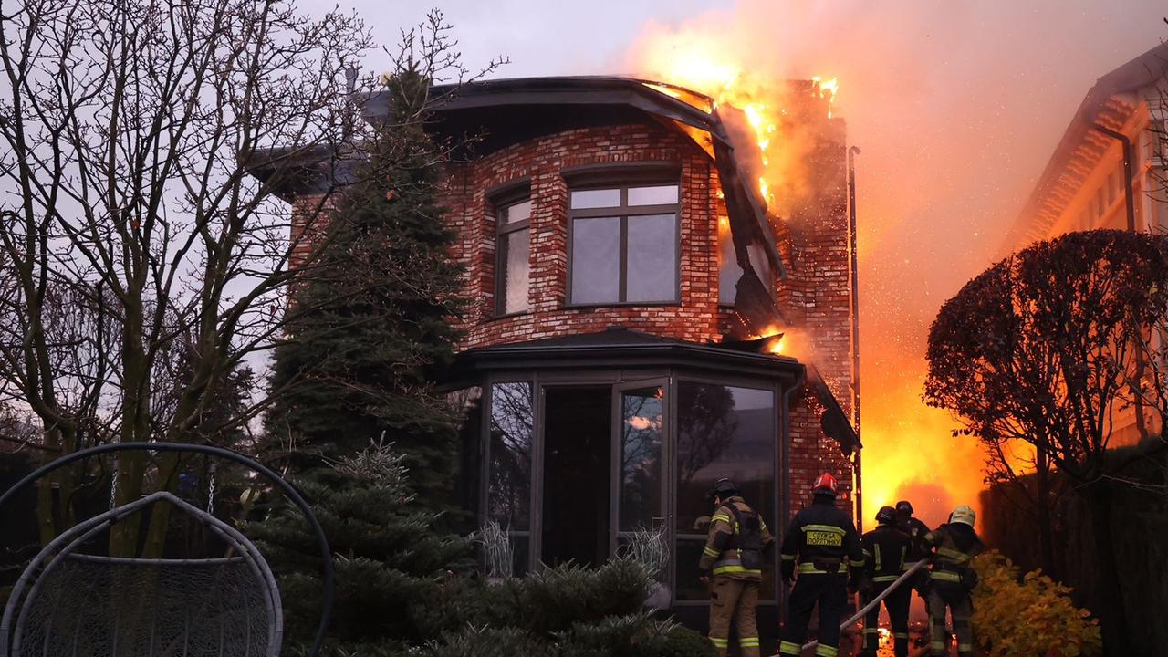 Ukrainian firefighters work on a burning building after air-attack, in Dnipro, where they claim Russia launched an intercontinental ballistic missile overnight. (AFP)