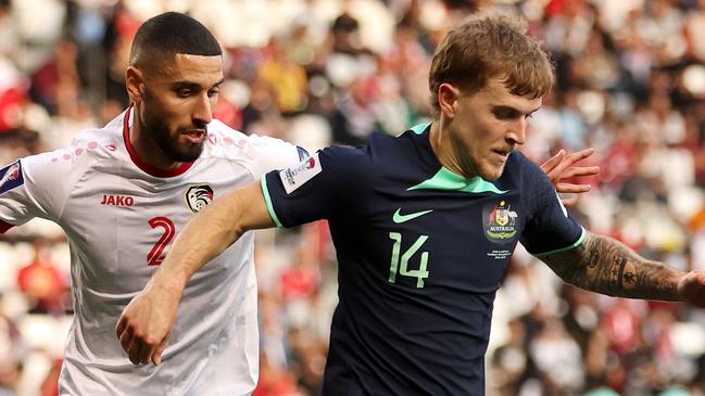 DOHA, QATAR - JANUARY 18: Riley McGree of Australia battles for possession with Aiham Ousou of Syria during the AFC Asian Cup Group B match between Syria and Australia at Jassim Bin Hamad Stadium on January 18, 2024 in Doha, Qatar. (Photo by Robert Cianflone/Getty Images)