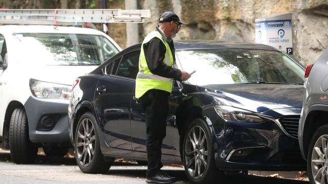 A City of Sydney parking officer on the job in the CBD. Picture: John Grainger