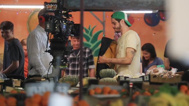 Hollywood actor and comedian Pete Davidson next to fresh produce on set of the movie Wizards, being filmed at Rusty's Markets in Cairns. Picture: Brendan Radke