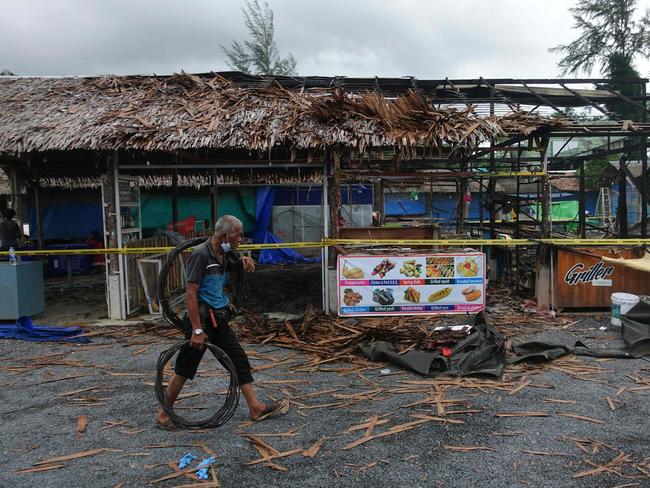 A man walks past the site of a bomb blast and arson attack on Bang Niang market near Khao Lak in Thailand. Picture: AFP/Jerome Taylor