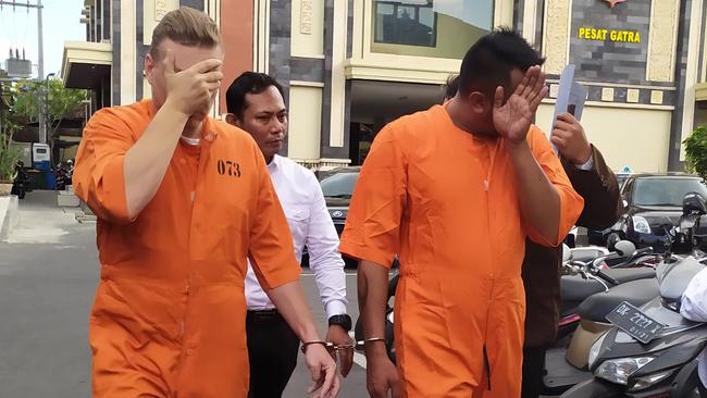 David Van Iersel and William Cabantog are escorted to Denpasar police station.