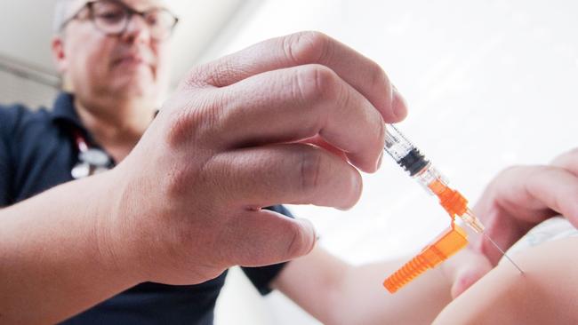 A doctor giving a measles vaccination. Picture: Julian Stratenschulte