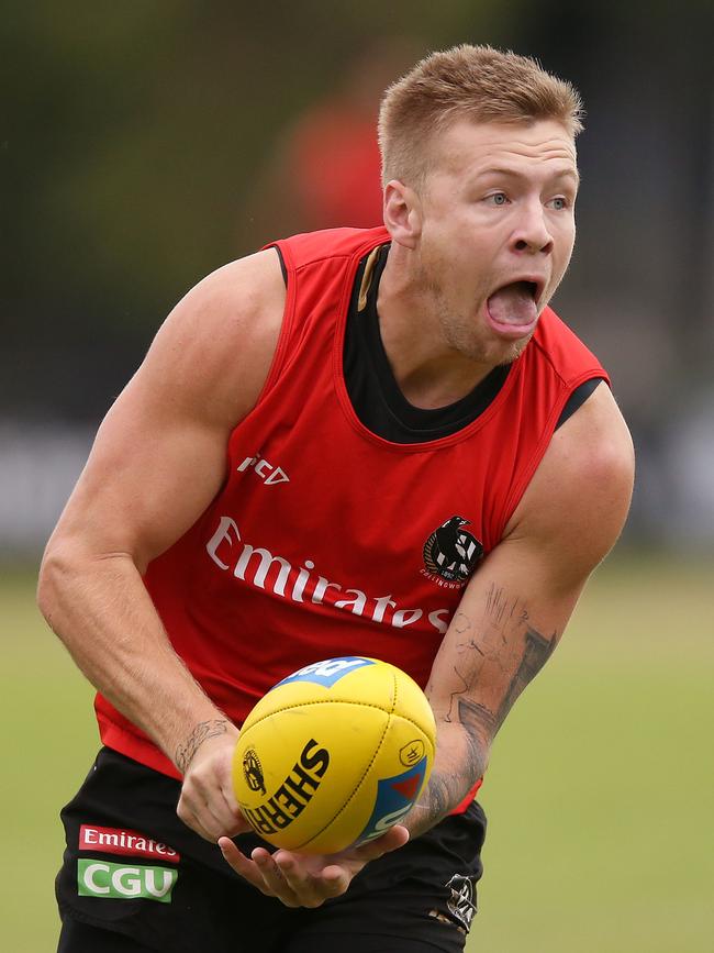 Jordan De Goey handballs at Collingwood training. 