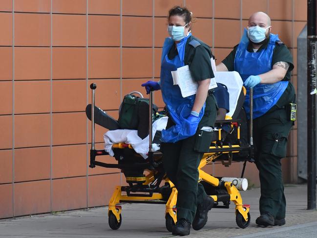 Paramedics wheel a patient into The Royal London Hospital in east London. Picture: AFP