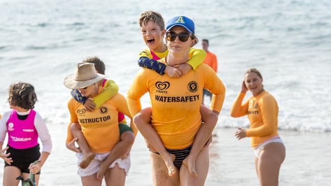 Avoca Beach competitor Max Stuart-Thornton is carried by Jemima Garven during the beach wade event at the Surf Life Saving Central Coast Inclusive Branch Carnival. Picture: Troy Snook