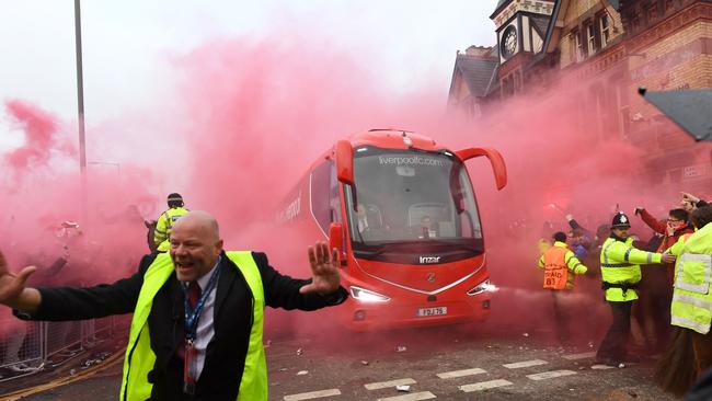 Police hold back supporters as Liverpool players arrive by bus