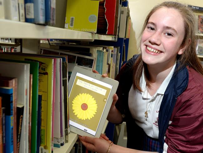 Future-proofing students ... A Melbourne high school student poses with an iPad to show that reading for literacy development and enjoyment can cut across platforms. Picture: Steve Tanner.