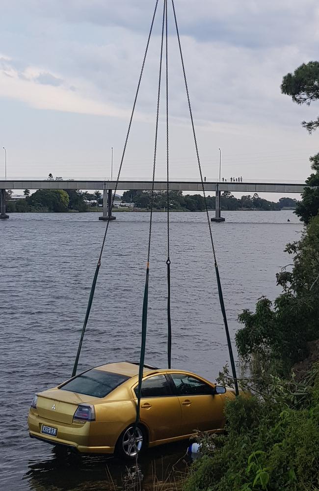 After the bodies were recovered, the car was lifted out of the river by a crane. Picture: Frank Redwood