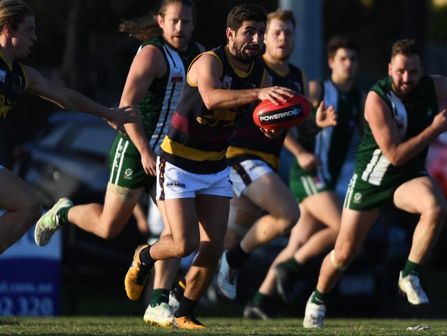 Doncaster East captain Nick Batsanis gets a kick away. Picture: James Ross/AAP