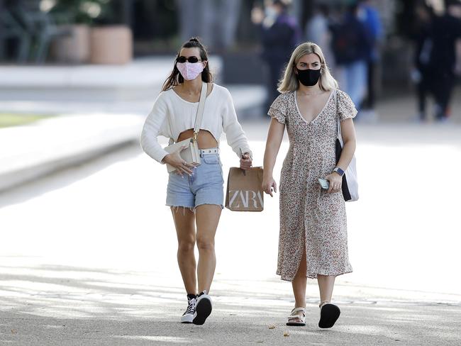 Women are seen wearing masks in Brisbane back in 2021