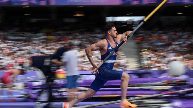 France's Anthony Ammirati showing his impressive pole. Photo by Andrej ISAKOVIC / AFP.