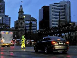 POWER OUT: Police direct traffic around the CBD in Adelaide after the power network stops working. Wednesday September, 28, 2016. Picture: DAVID MARIUZ-AAP