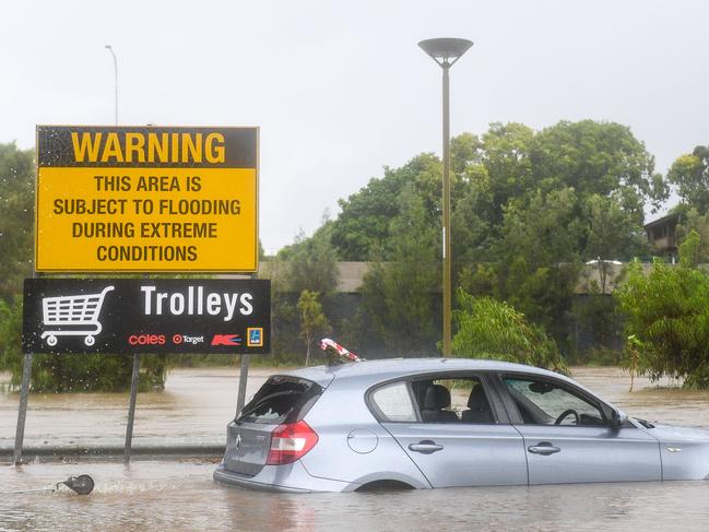 A car sits in flood waters in the Toombul Shopping Centre car park, north of Brisbane, Thursday, March 30, 2017. A severe rain depression is currently taking place throughout south-east Queensland on the back of ex-Tropical Cyclone Debbie. (AAP Image/Albert Perez) NO ARCHIVING, EDITORIAL USE ONLY