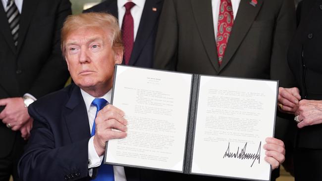 US President Donald Trump signs trade sanctions against China. Picture: AFP/ Mandel NGAN