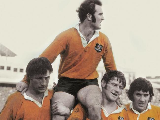 Wallaby captain John Hipwell is chaired from the field by Reg Smith (left) and Stuart MacDougall after Australia’s Test against England at the Sydney Cricket Ground in 1975.