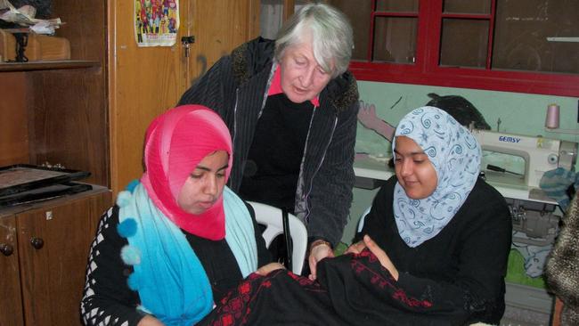 The late Jean Calder with young women completing vocational training in embroidery.