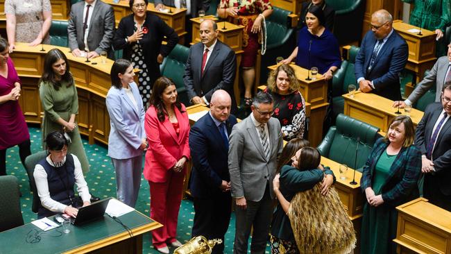 Jacinda Ardern hugs members of parliament after giving her valedictory speech. Picture: AFP.