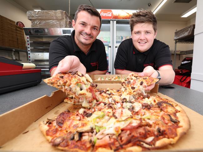 Merlins Pizza has been named the best on the Gold Coast. Co-owners Jordan Powell and Scott Jelich with some of their tasty treats. Picture Glenn Hampson